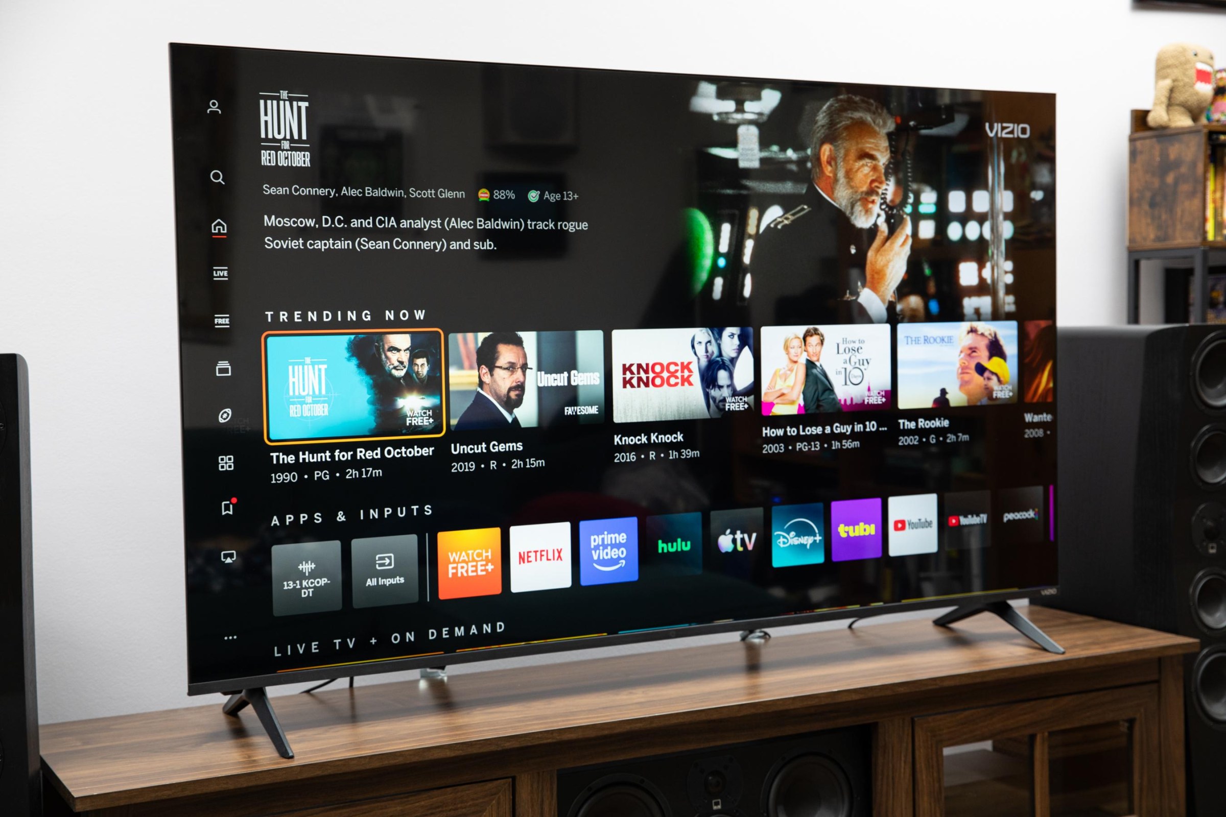 The Vizio Mini LED Quantum display the Vizio OS home page, on a wooden credenza.