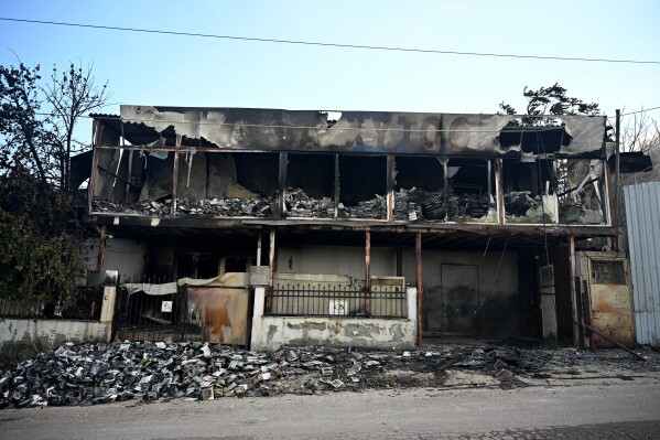 A view of a burnt building from a wildfire on the outskirts of the northern city of Thessaloniki, Greece, Sunday, July 5, 2026. (AP Photo/Giannis Papanikos)
