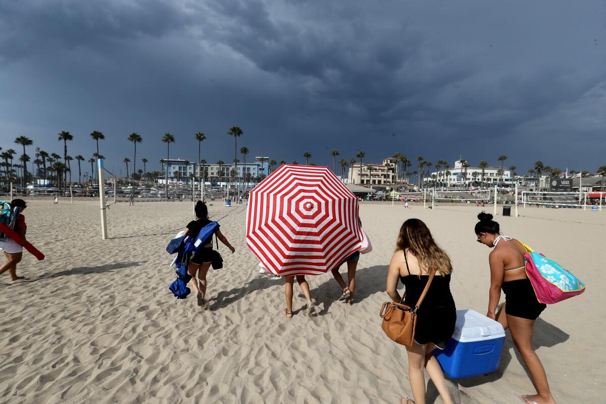 Some people bring smaller umbrellas to the beach.