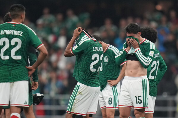Mexico players react at the the end of the World Cup round of 16 soccer match between Mexico and England in Mexico City, Sunday, July 5, 2026. (AP Photo/Silvia Izquierdo)