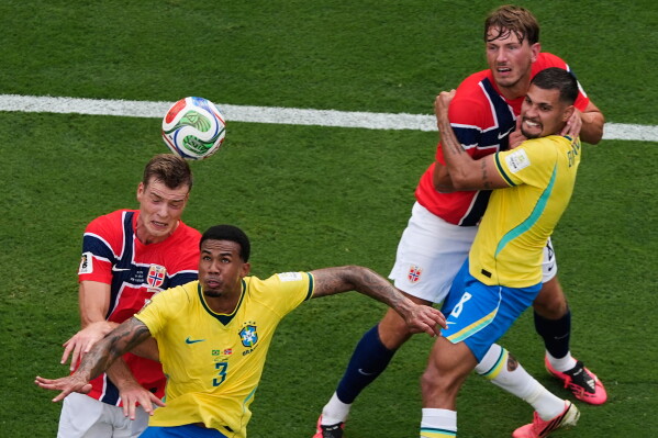Norway's Alexander Soerloth, left, and Brazil's Gabriel Magalhaes (3) battle for a head ball as Brazil's Bruno Guimaraes (8) and Norway's Sander Berge, second from right, tussle during the World Cup round of 16 soccer match between Brazil and Norway in East Rutherford, N.J., near New York, Sunday, July 5, 2026. (AP Photo/Matt Slocum)