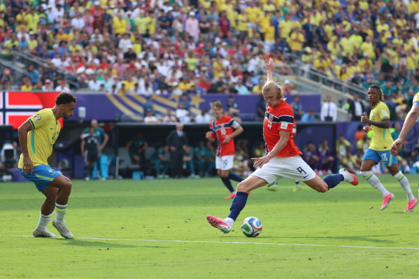 Norway's Erling Haaland (9) shoots and scores their second goal during the World Cup round of 16 soccer match between Brazil and Norway in East Rutherford, N.J., near New York, Sunday, July 5, 2026. (AP Photo/Pamela Smith)