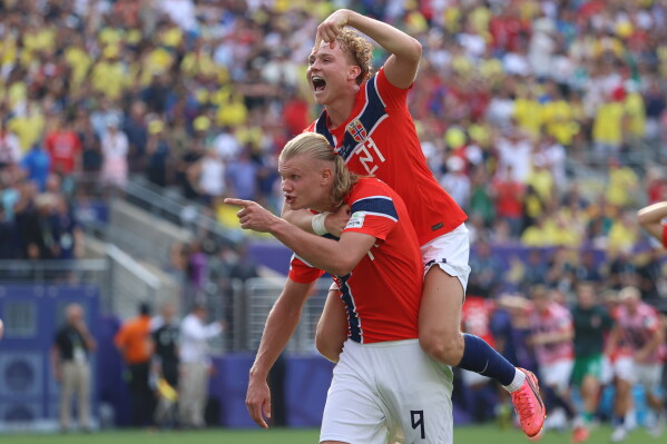 Norway's Erling Haaland (9) celebrates with Andreas Schjelderup (21) after scoring their second goal during the World Cup round of 16 soccer match between Brazil and Norway in East Rutherford, N.J., near New York, Sunday, July 5, 2026. (AP Photo/Pamela Smith)