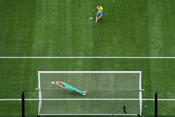 Norway goalkeeper Oerjan Nyland (1) saves a penalty kick by Brazil's Bruno Guimaraes (8) during the World Cup round of 16 soccer match between Brazil and Norway in East Rutherford, N.J., near New York, Sunday, July 5, 2026. (AP Photo/Stephen K.H. Moyes)