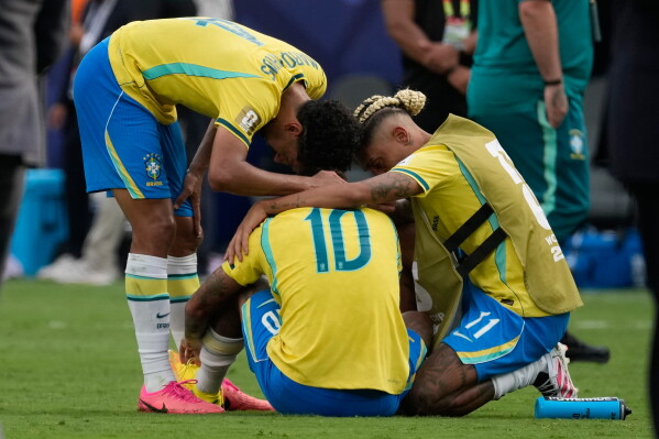 Brazil's Marquinhos, left, Neymar (10) and Raphinha react after losing to Norway the World Cup round of 16 soccer match between Brazil and Norway in East Rutherford, N.J., near New York, Sunday, July 5, 2026. (AP Photo/Seth Wenig)