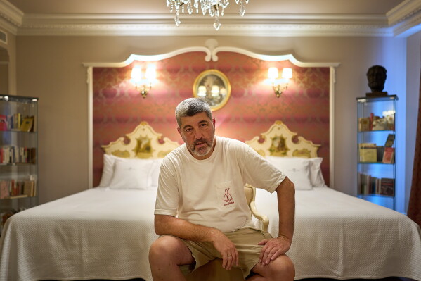 Former concierge and receptionist Fernando Hualde poses at the Ernest Hemingway suite at the Gran Hotel La Perla in Pamplona, northern Spain, Thursday, July 2, 2026. (AP Photo/Miguel Oses)