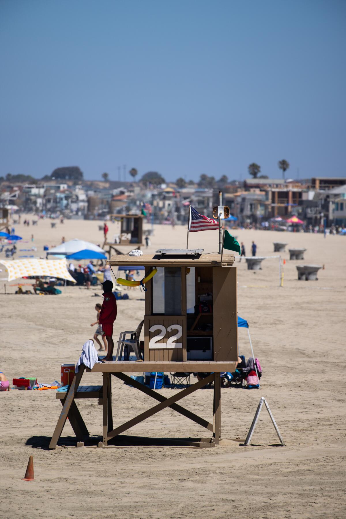 A Newport Beach lifeguard watches over beachgoers on July 6 in Newport Beach.