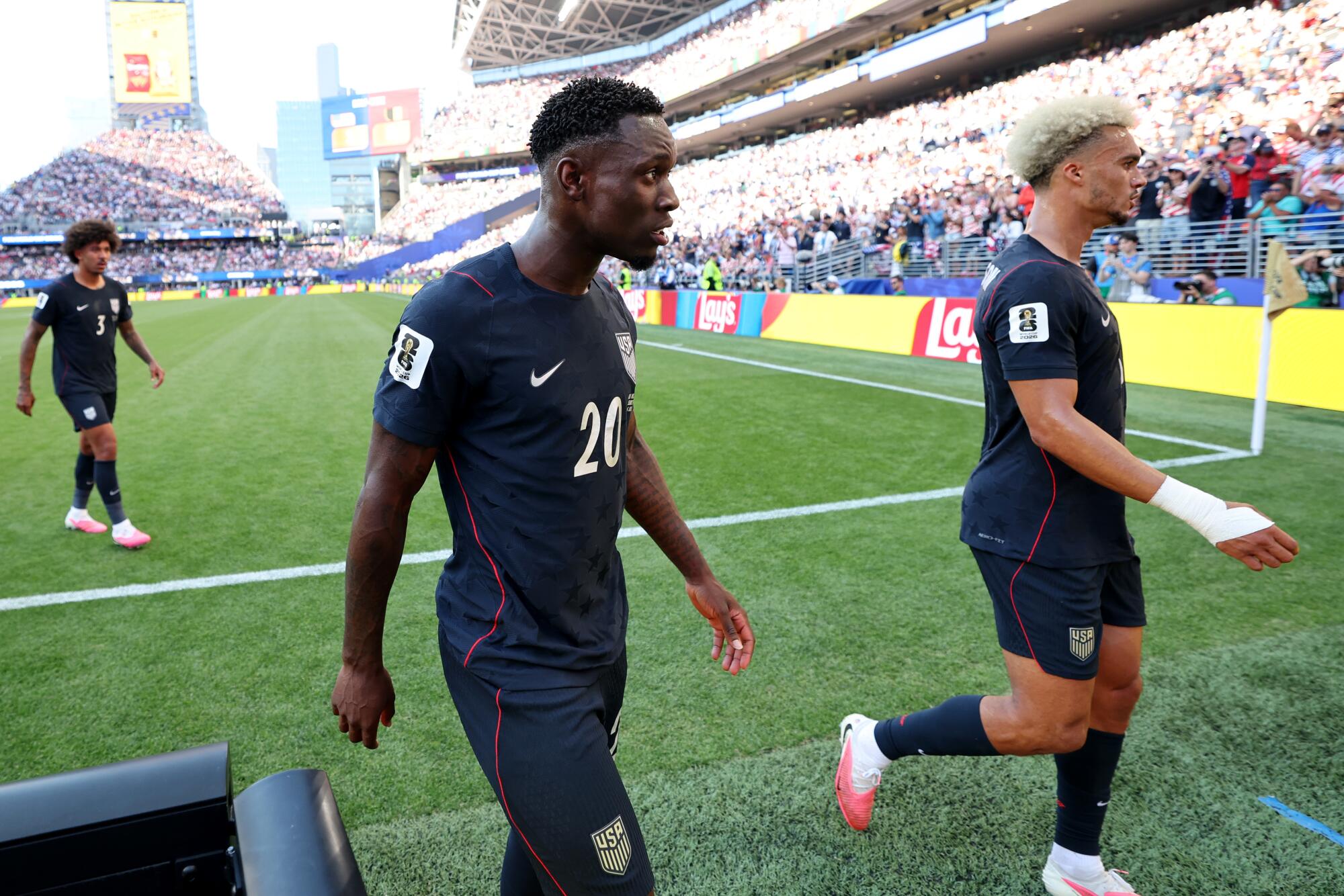U.S. striker Folarin Balogun (20) walks to the locker room at halftime against Belgium in the World Cup.