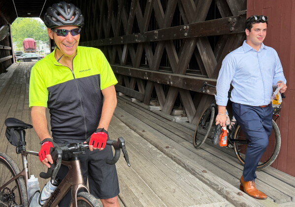 Rahm Emanuel takes a break from a bike ride through New Hampshire, Saturday, June 6, 2026. (AP Photo/Steven Sloan)