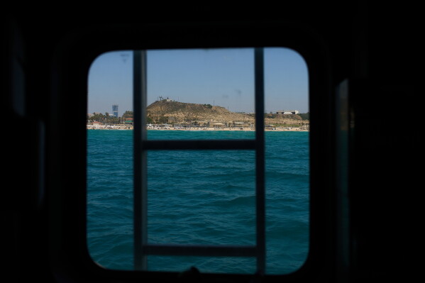 A military firing range that had been used for decades and is slated to be cleared and opened for public use, is visible through a boat in the Mediterranean Sea in off the coast of Rishon Lezion, Israel, Sunday, June 21, 2026. (AP Photo/Ariel Schalit)