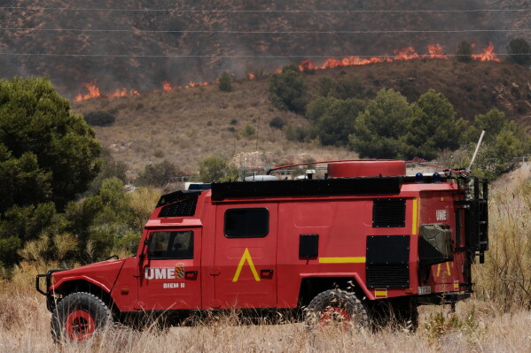 A Military Emergency Unit vehicle operates as a wildfire rages in Alfajir, near Almeria in southeastern Spain, Friday, July 10, 2026. (AP Photo/Gregorio Marrero)
