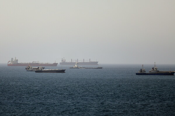 Tankers and cargo vessels are seen in the Gulf of Oman, along shipping routes linking the Strait of Hormuz and the Arabian Sea, Tuesday, June 16, 2026. (AP Photo)