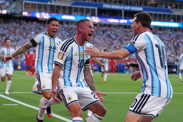 Argentina's Alexis Mac Allister, center, celebrates scoring their first goal with Lionel Messi during the World Cup quarterfinal soccer match between Argentina and Switzerland in Kansas City, Mo., Saturday, July 11, 2026. (AP Photo/Abbie Parr)