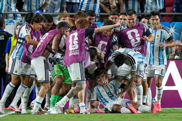 Argentina's Julian Alvarez (9) is congratulated by teammates after scoring his team's second goal during the World Cup quarterfinal soccer match between Argentina and Switzerland in Kansas City, Mo., Saturday, July 11, 2026. (AP Photo/Ashley Landis)
