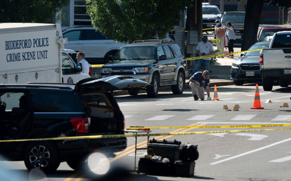 An FBI official places an evidence card where a man was reportedly killed in a shooting involving U.S. Immigration and Customs Enforcement agents, Monday, July 13, 2026 in Biddeford, Maine. (Gregory Rec/Portland Press Herald via AP)