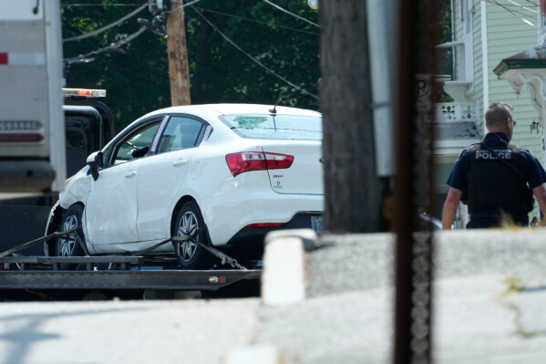 A vehicle with a damaged window is transported from the scene of a shooting involving U.S. Immigration and Customs Enforcement, Monday, July 13, 2026 in Biddeford, Maine. (AP Photo/Robert F. Bukaty)