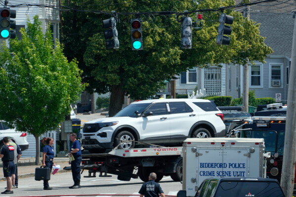 A vehicle is transported on a flatbed near the scene of a shooting involving U.S. Immigration and Customs Enforcement, Monday, July 13, 2026 in Biddeford, Maine. (AP Photo/Robert F. Bukaty)