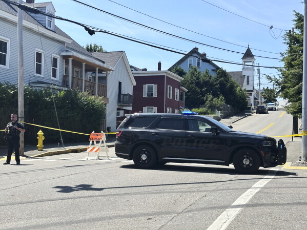 Police block a road after a shooting in Biddeford, Maine, Monday, July 13, 2026. (AP Photo/Patrick Whittle)