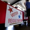 People stand near a voter registration table at a 2022 event in Fredericksburg, Texas.