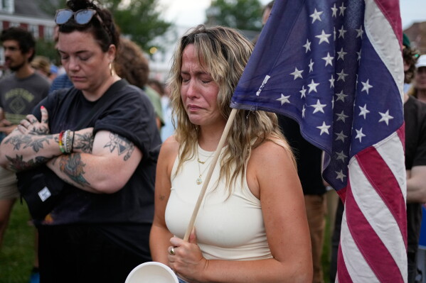 A demonstrator fights back tears at an anti-ICE rally after a man was shot and killed by U.S. Immigration and Customs Enforcement on Monday, July 13, 2026, in Biddeford, Maine. (AP Photo/Robert F. Bukaty)