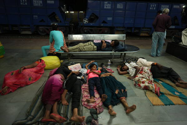 Residents sleep on the platform of a railway station to escape the heat in Banda, northern Indian state of Utter Pradesh, Saturday, June 20 , 2026. (AP Photo/Rajesh Kumar Singh)