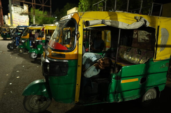 An auto-rickshaw driver rests inside his vehicle during a heat wave in Banda, northern Indian state of Utter Pradesh, Saturday, June 20 , 2026. (AP Photo/Rajesh Kumar Singh)