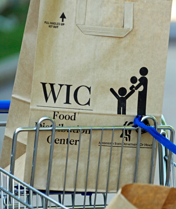 A Special Supplemental Nutrition Program for Women, Infants and Children, better known as WIC, bag sits in a shopping cart in Jackson, Miss., Oct. 3, 2013. (AP Photo/Rogelio V. Solis, File)