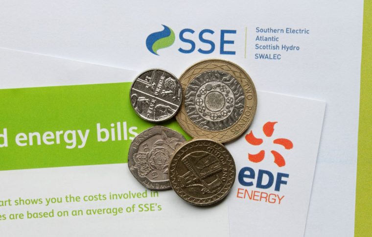 This is a generic photo of coins on top of an energy bill letter. See PA Feature FINANCE Energy Cap. WARNING: This picture must only be used to accompany PA feature FINANCE Energy Cap. PA Photo. Picture credit should read: Alamy/PA. NOTE TO EDITORS: This picture must only be used to accompany FINANCE Energy Cap.