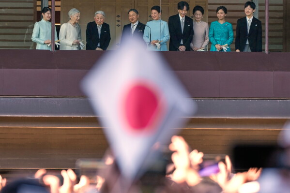 Japan's Emperor Naruhito, fourth left, Empress Masako, fifth left, and other royal family members greet well-wishers from the balcony during a public appearance for New Year's celebrations at the Imperial Palace, Jan. 2, 2026, in Tokyo. (AP Photo/Eugene Hoshiko, File)