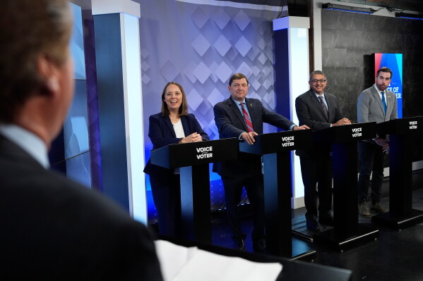 From podium left, U.S. Senate candidates Shenna Bellows, Troy Jackson, Dr. Nirav Shah, and Jordan Wood talk with moderator Phil Hirschkorn at WCSH-6 before a televised debate at the WCSH-6 studio Thursday, July 16, 2026, in Portland, Maine. (AP Photo/Robert F. Bukaty)