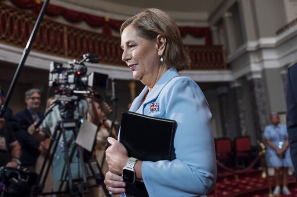 Newly-sworn Sen. Darline Graham, R-S.C., sister of Lindsey Graham, walks past cameras as she leaves the Old Senate Chamber following a cermonial oath of office ceremony allowing her to serve as her late brother's temporary replacement, at the Capitol in Washington, Tuesday, July 14, 2026, (AP Photo/J. Scott Applewhite)
