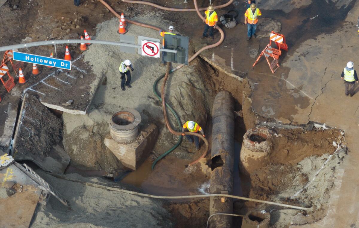 Repair work is underway after a water main break flooded streets