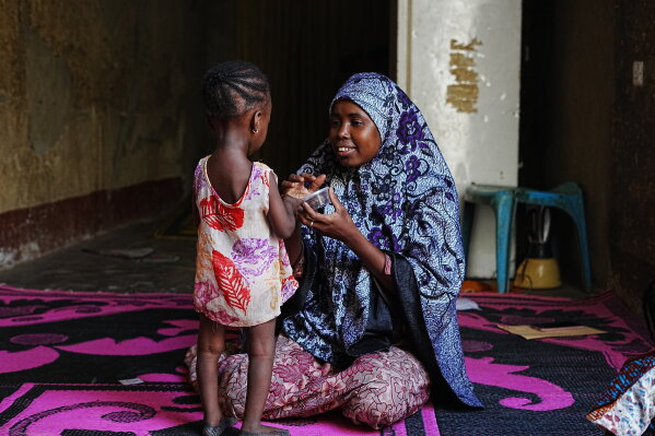 Maryam Aminu plays with her daughter Farisa, who has relapsed into malnutrition, at their house in Kware Sokoto, northwestern Nigeria, Wednesday, July 15, 2026. (AP Photo/Sunday Alamba)