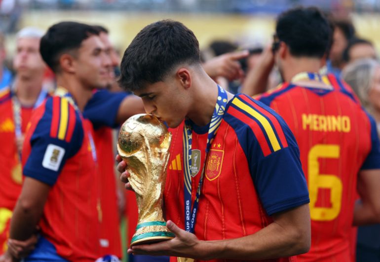 Spain’s Pau Cubarsi kisses the trophy as he celebrates after winning the World Cup