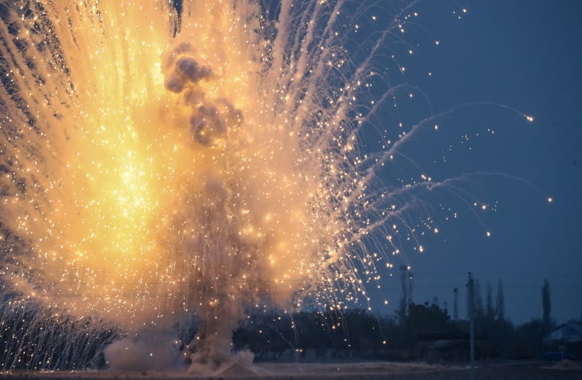 Unexploded ordinance, an artillery shell containing white phosphorous, is detonate