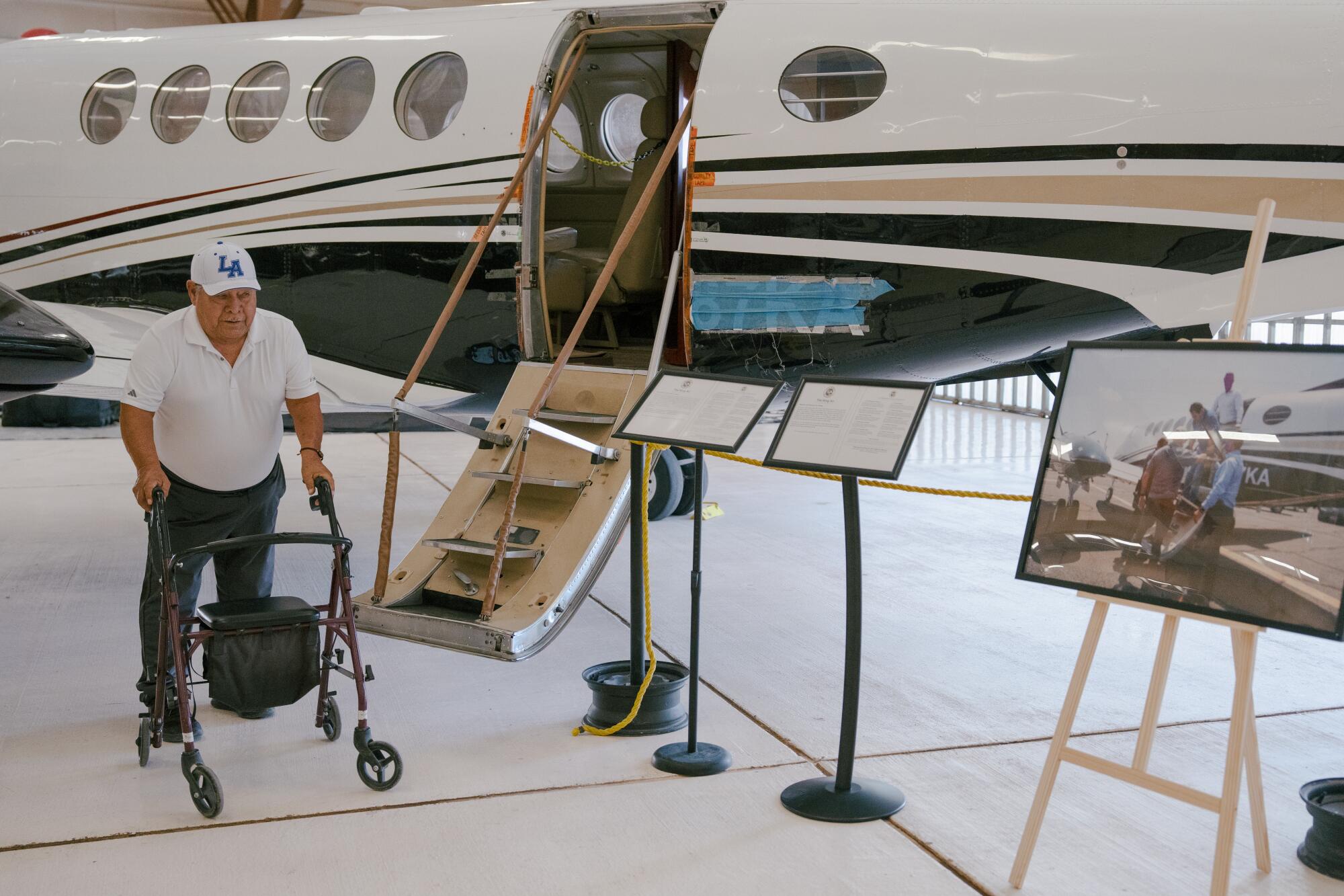 Ricardo Martinez, 75, of Horizon City, Texas, looks at the exhibit of a Beechcraft King Air aircraft