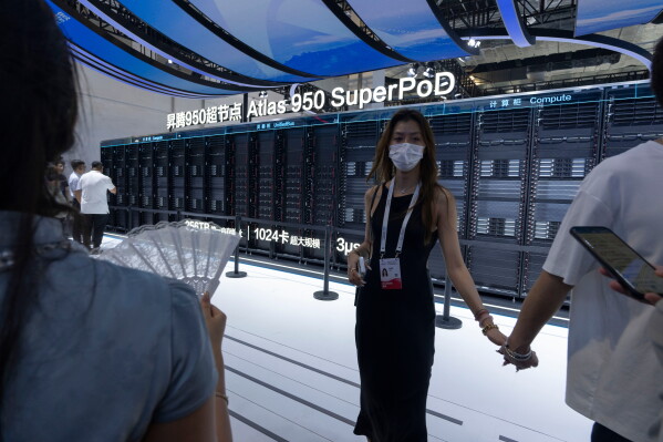 Visitors stand near the Huawei Atlas 950 SuperPod during the World AI Conference in Shanghai, Friday, July 17, 2026. (AP Photo/Ng Han Guan)