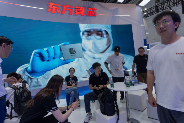 Visitors at the booth for Eastern Computing Chips a Chinese AI semiconductor company at the World AI Conference in Shanghai, Friday, July 17, 2026. (AP Photo/Ng Han Guan)
