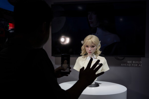 A lifelike robot head looks at a visitor during the World AI Conference in Shanghai, Friday, July 17, 2026. (AP Photo/Ng Han Guan)
