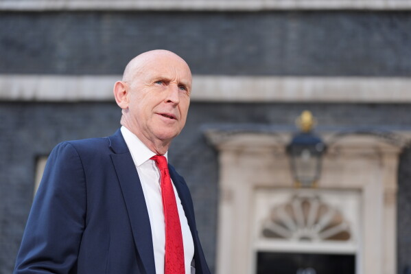 Newly appointed Chancellor of the Exchequer John Healey leaves number 10 Downing Street, as new British Prime Minister Andy Burnham has entered number 10 Downing Street and among his first tasks is the selection of his new Cabinet, in London, Monday July 20, 2026. (Yui Mok/PA via AP)