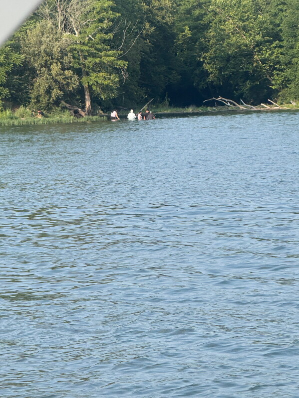 In this photo provided by Pastor Marcus L. Martin, a group of people he believes were those who died in a recent drowning accident, are shown fishing along the Scioto river in Powell, Ohio, Sunday, July 19, 2026. (Pastor Marcus L. Martin via AP)