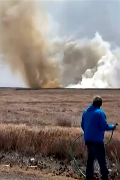 This still image taken from video shows a plume of smoke rising above a plain near Mountain Home Air Force Base, Idaho, where two Navy jets collided at an air show on Sunday, May 17, 2026. (Lisa Van Horne via AP)