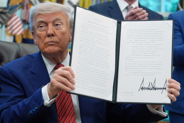 President Donald Trump holds an executive order regarding reinvigorating the nuclear industrial base in the Oval Office of the White House, May 23, 2025, in Washington. (AP Photo/Evan Vucci, File)