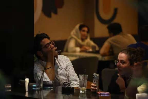 A customer smokes a cigarette inside a café in central Tehran. (File photo)