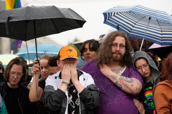 People gather outside the Brandenburg Gate for a demonstration in support of LGBTQ+ after a car rammed into a crowd at the Pride March in Berlin, Sunday, July 26, 2026. (AP Photo/Ebrahim Noroozi)