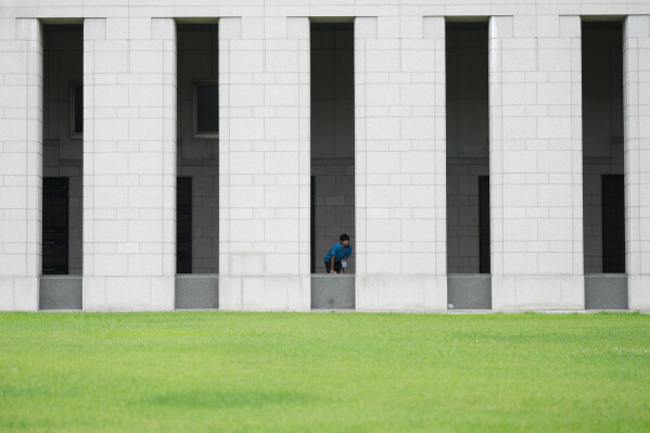 South Korean student Min Woo-jin looks at monuments with the names of soldiers killed during the 1950-53 Korean War, at the War Memorial of Korea in Seoul, South Korea, Sunday, July 5, 2026. (AP Photo/Lee Jin-man)