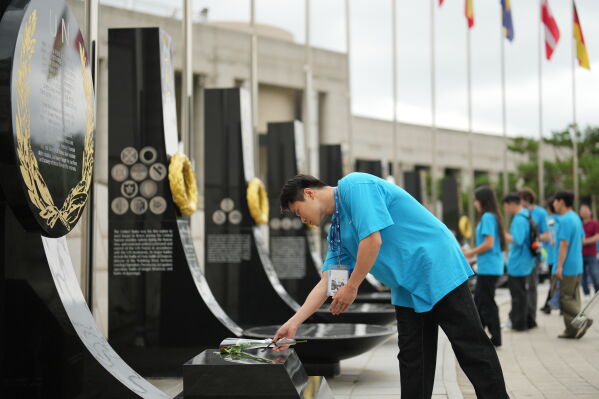 South Korean Jo Suk-hyun places flower at Korean War veterans memorial in Seoul, South Korea, Sunday, July 5, 2026. (AP Photo/Lee Jin-man)