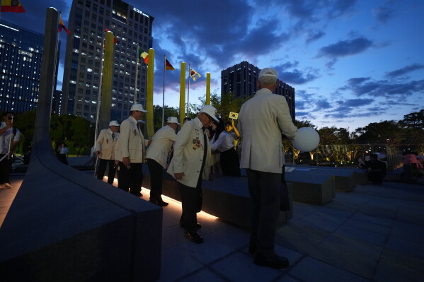 Korean War veterans are greeted after a ceremony to mark the 76th anniversary of the outbreak of the Korean War in Seoul, South Korea, Tuesday, June 23, 2026. (AP Photo/Lee Jin-man)