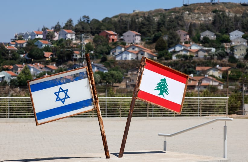 Representations of the Israeli and Lebanese flags at a memorial near the Israel-Lebanon border, after Israel and Lebanon signed a framework agreement following U.S.-mediated talks, as the town of Metula, Israel, appears in the distance, June 27, 2026.