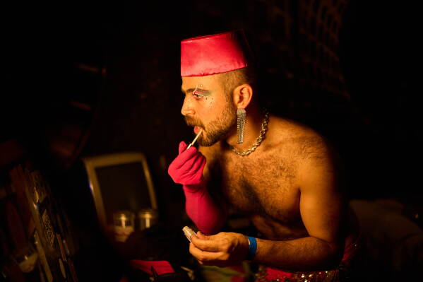 Haidar Darwish, a Syrian belly dancer with the Berlin-based LGBTQ collective Queens Against Borders, prepares backstage before an open-air show in Berlin, Germany, Friday, July 17, 2026. (AP Photo/Ebrahim Noroozi)